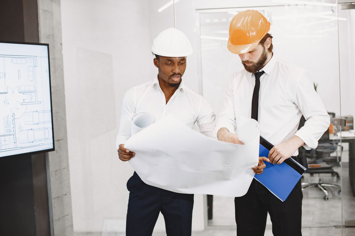 Professionals reviewing building plans on site