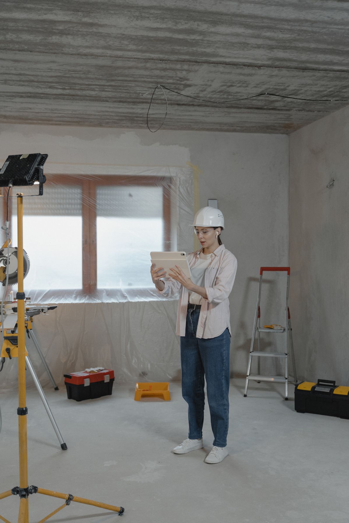 Assessor with a tablet inspecting a building interior